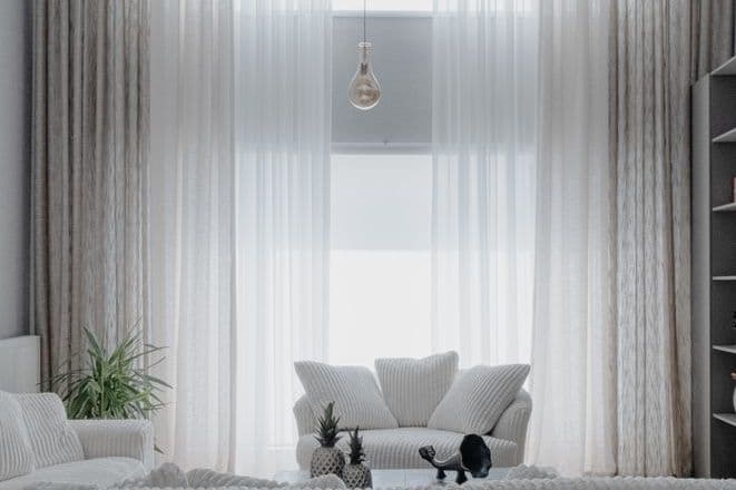A bright living room with a sofa and soft furnishings
